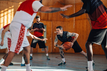 Naklejka premium Diverse basketball players in action playing a basketball on training.