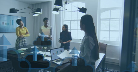 Image of arrow on clouds over diverse female coworkers discussing reports in office