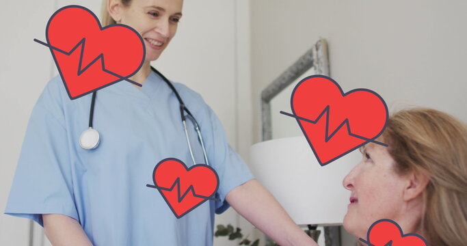 Image of hearts with cardiograph over caucasian female doctor and patient