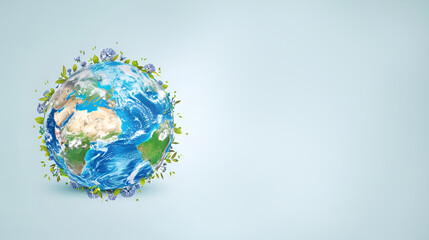 Fototapeta premium Earth day illustration planet earth with green branches and flowers on blue studio background with copy space, nature eco theme holiday banner