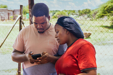 volunteer teaching a woman how to use the internet in an african village, charity organization