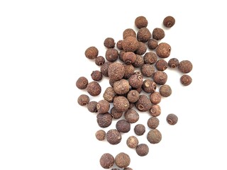 Allspice berries on a white background.