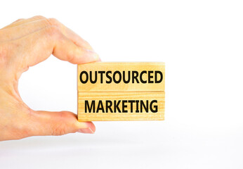 Outsourced marketing symbol. Concept words Outsourced marketing on beautiful wooden blocks....