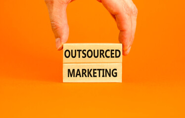 Outsourced marketing symbol. Concept words Outsourced marketing on beautiful wooden blocks....