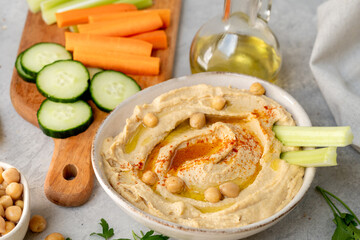 healthy snack fresh hummus with paprika with celery, carrots, cucumber, with chickpeas and olive oil, healthy lunch food