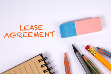 Lease Agreement. Colored pencils and eraser on a white table