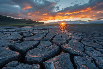 Fototapeten Sunset over cracked earth, ideal for environmental campaigns or nature documentaries © Blue_Utilities