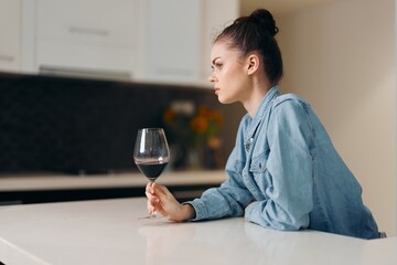Wine and Loneliness: A Depressed Woman Drinking Alone in a Modern Kitchen