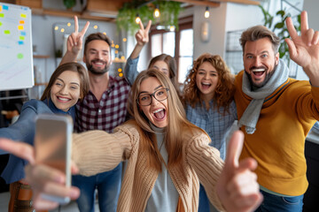 An energetic group of colleagues from the marketing department share a joyful selfie moment, with an enthusiastic nod of approval in a cozy office environment. Successful strategies.