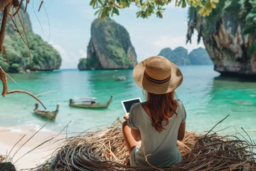 Photo sur Plexiglas Railay Beach, Krabi, Thaïlande  Traveler woman relaxing on straw nests using tablet at Railay beach Krabi, Asia business people on vacation at resort work with computer notebook, Tourist travel Phuket Thailand summer holiday trip