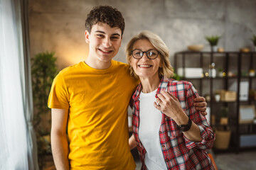 portrait of mother and son mature woman and young man at home happy - Powered by Adobe