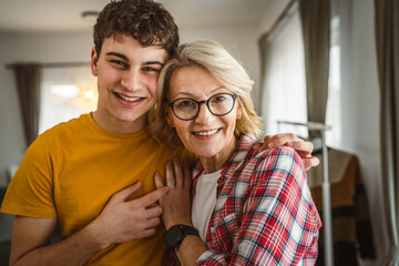 portrait of mother and son mature woman and young man at home happy