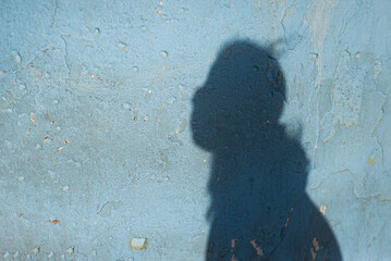 Shadow cast on a wall by an unidentified person.