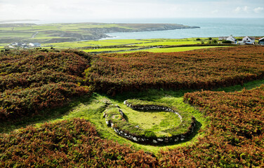 Holyhead Mountain Ty Mawr Hut Circles. Part of Prehistoric Neolithic through Iron Age house settlement stone foundations. Anglesey, Wales. View south - obrazy, fototapety, plakaty