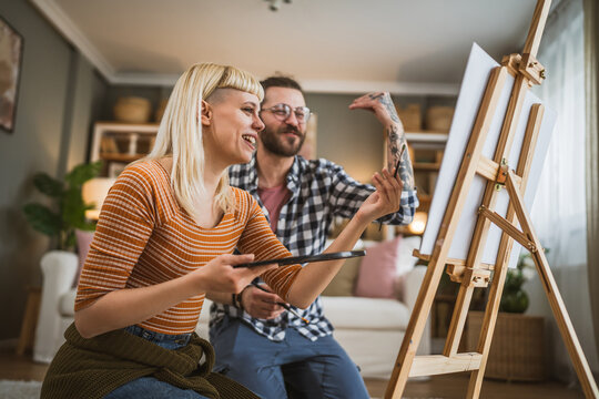 couple man and woman paint on canvas on easel at home leisure hobby