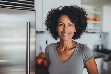 Portrait of a fit middle aged woman in kitchen