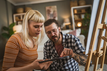 couple man and woman paint on canvas on easel at home leisure hobby