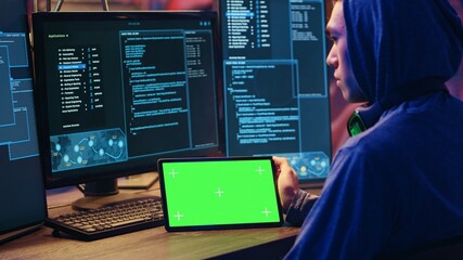Hackers doing computer sabotage using encryption trojan ransomware on green screen tablet....