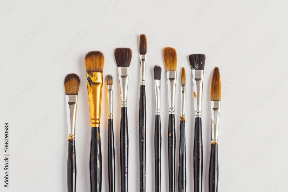 Poster This image displays a wide array of paintbrushes that vary in bristle type and handle design, set against a white backdrop