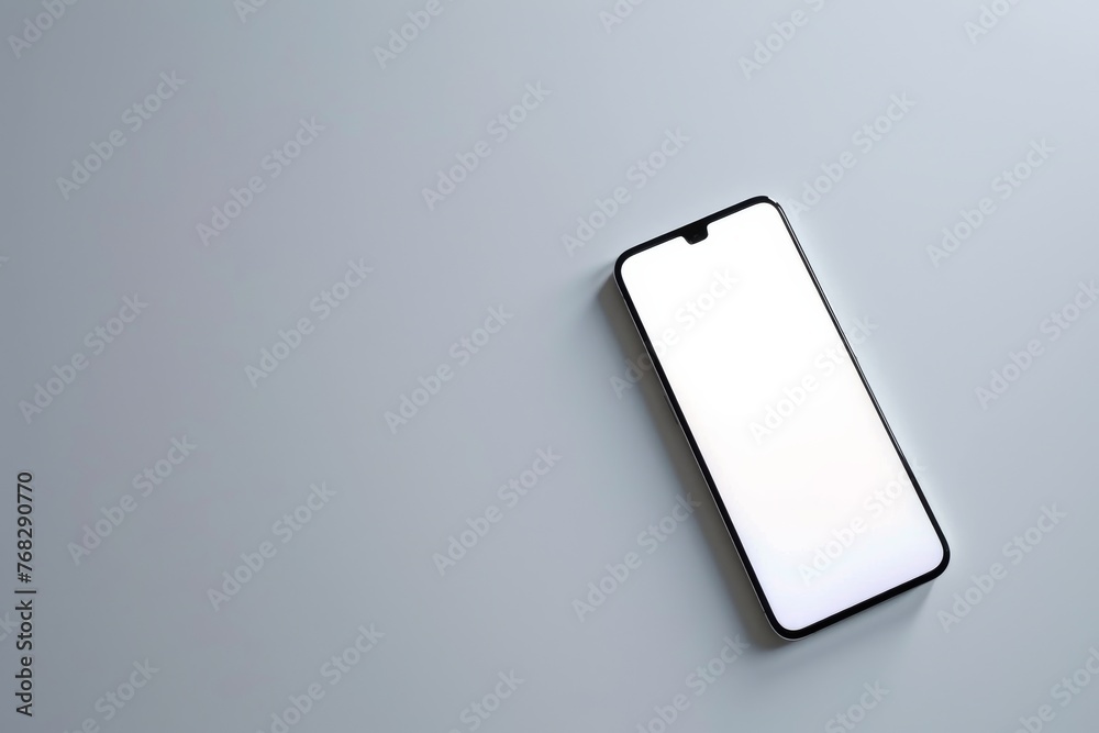 Poster a contemporary smartphone with a blank screen lying diagonally on a plain gray background suitable f