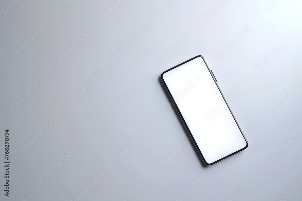 Aufkleber A minimalist setup featuring a smartphone with a blank screen on a tidy gray surface, ideal for design mockups