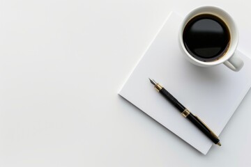 A simple and elegant setup of a white notebook with a black fountain pen and a coffee cup on a white background