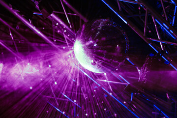 Shining disco ball with purple lights. 