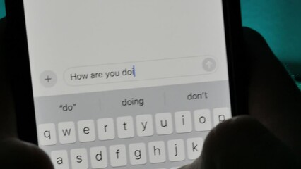 Person typing "How are you doing?" text message on a smartphone