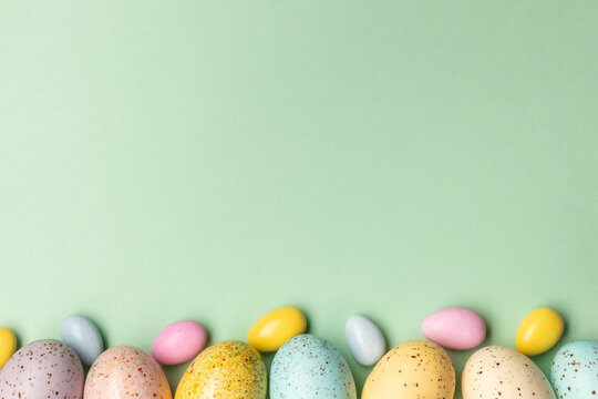 easter eggs and easter candy on green surface