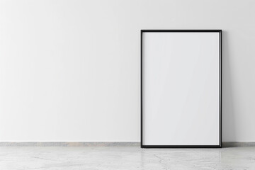 photograph of a poster frame leaning against a minimalist white wall, ready for graphic posters or advertising content
