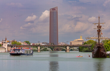 Tourist boats on the Guadalquivir River on a sunny day. - 768306359