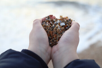 manos de niño con arena de una playa de Baiona en Galicia - 768307725