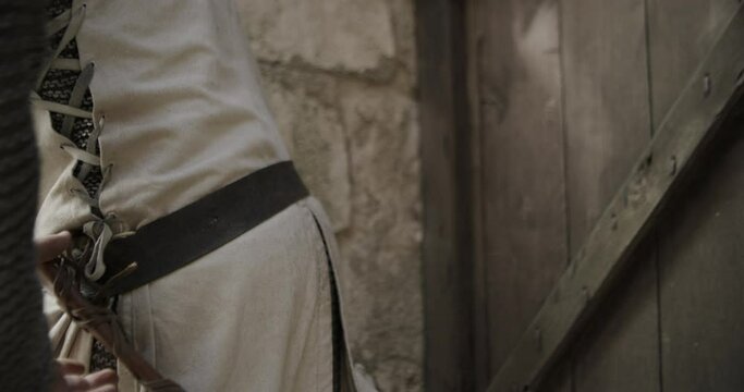 Close up on knight pulling out dagger