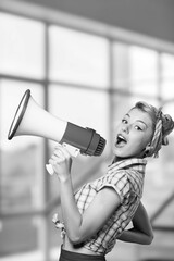 Black and white young woman shouting in megaphone
