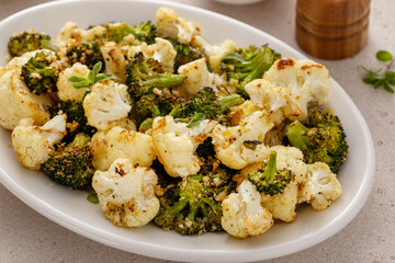 Roasted cauliflower and broccoli on a serving plate, healthy vegetable side dish