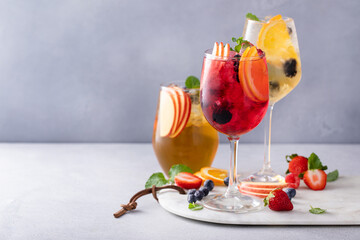 Refreshing summer sangria with berries and fruits with red and white wine - obrazy, fototapety, plakaty