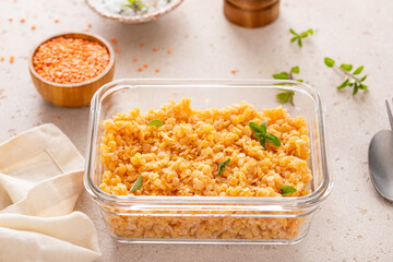 Cooked red lentils in a meal prep container, healthy vegan protein source