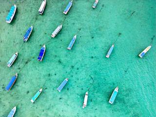 tourist boats on tropical sea in Belitung, Indonesia, drone aerial top down view