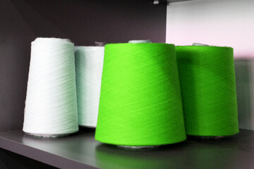 Colorful sewing threads wound on a thread spool. textile