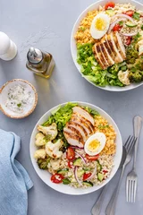 Fototapeten Healthy lunch bowl with grilled chicken, roasted vegetables, fresh lettuce, cooked lentils, salad and boiled egg © fahrwasser