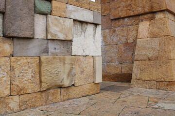 Close-up view of a wall made of several colored natural stones. decor harmony vision.