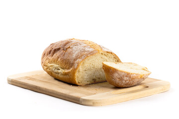 A whole loaf of artisanal crusty bread with the heel end cut off on a wooden cutting board isolated on white

