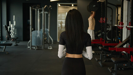 Back view from behind unrecognizable woman fitness trainer sportswoman girl going walking in sports...