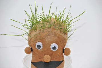 A Green Friend with Recycled Materials and Birdseed as Hair, in preschool environmental education...