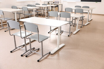 Empty school classroom with desks and chairs