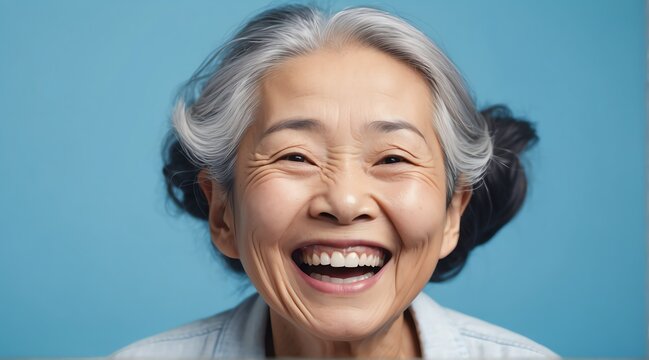 young asian elderly woman on plain bright blue background laughing hysterically looking at camera background banner template ad marketing concept from Generative AI