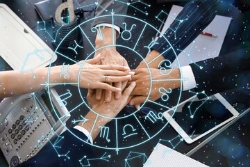 Workers putting hands together in office, top view. Business partner compatibility horoscope