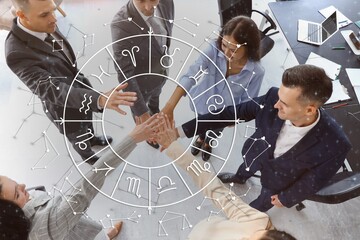 Workers putting hands together in office, top view. Business partner compatibility horoscope