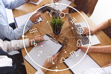 People at table in conference hall. Business horoscope