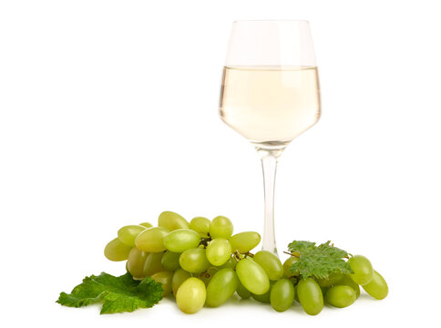 Glass of white wine with grapes on white background